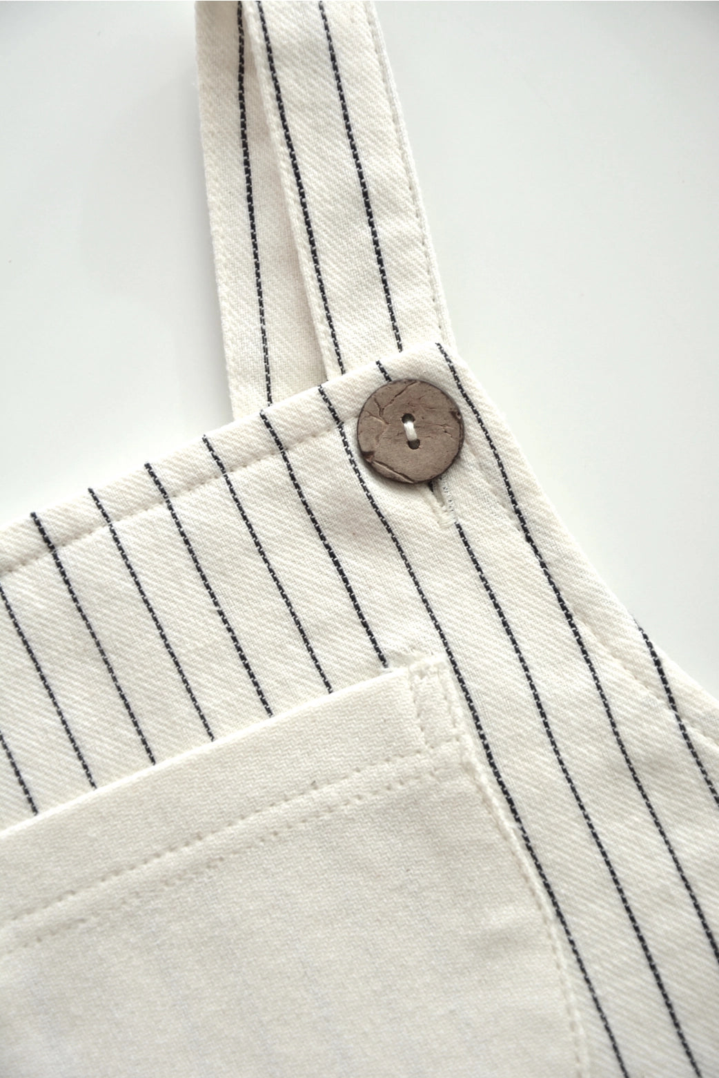 Close up of button on Eli & Nev Baby/Kid's Overalls - Emilien/Stripes